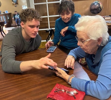 students from Teens Who Tech help elderly individuals feel more comfortable with technology devices