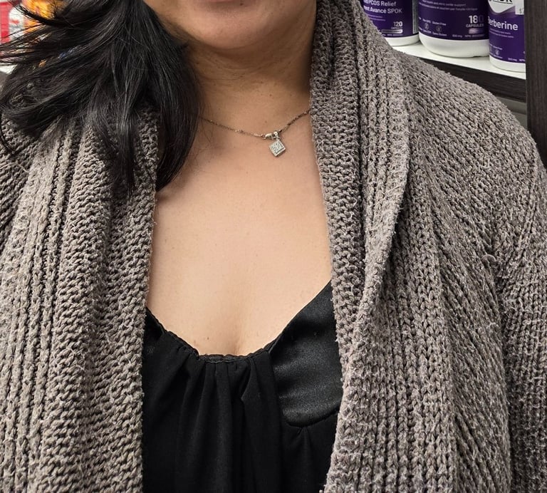 A woman smiling with medium length black hair