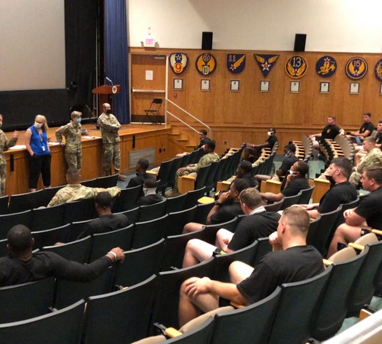 Dr. Hooton, in blue, with History faculty and students in an auditorium discussing teaching and race