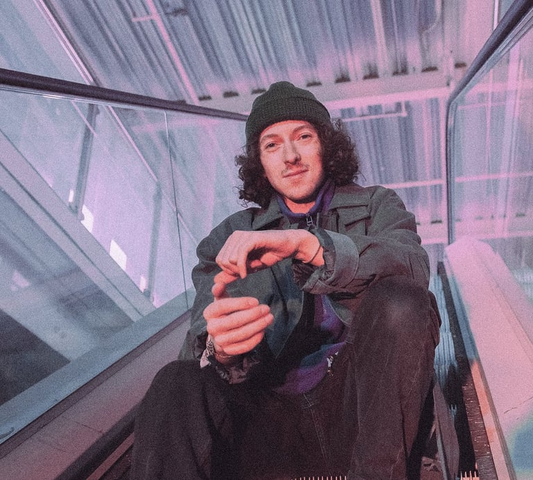 Photographic image of In VideColour's Sam Auckland, sitting in an industrial environment.
