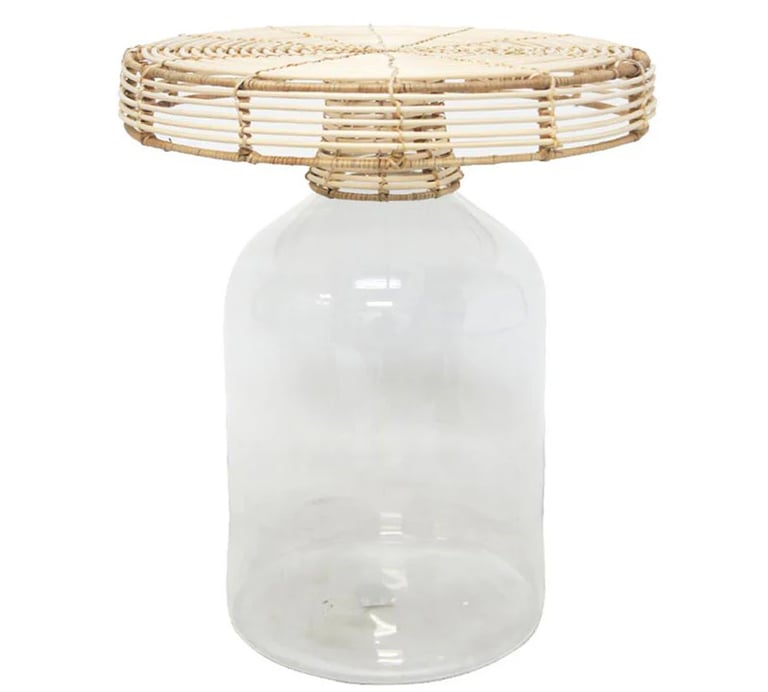 a blown glass side coffee table with a rattan on top of it