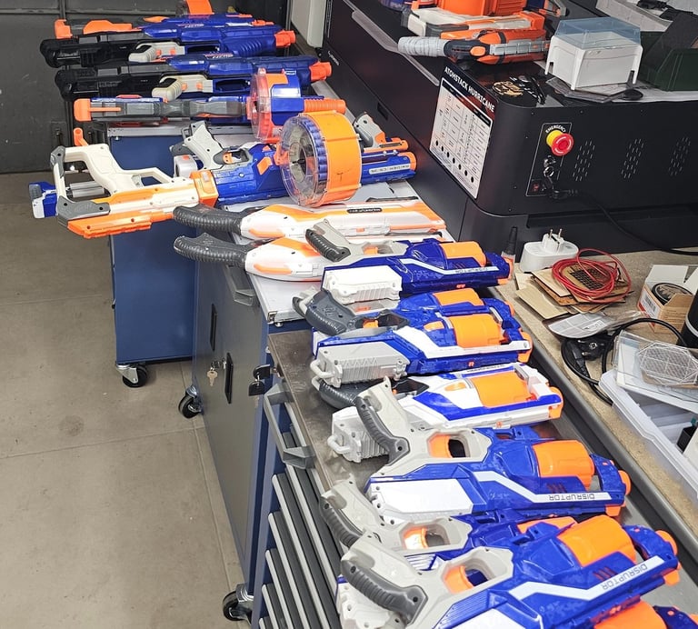 a bunch of nerfet guns are lined up on a table