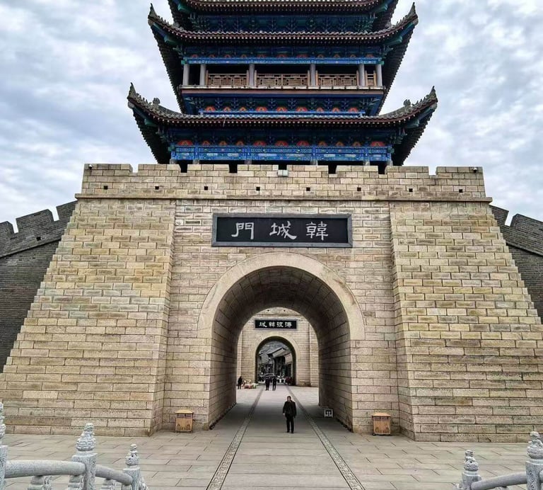 a person walking through a stone wall with a gate