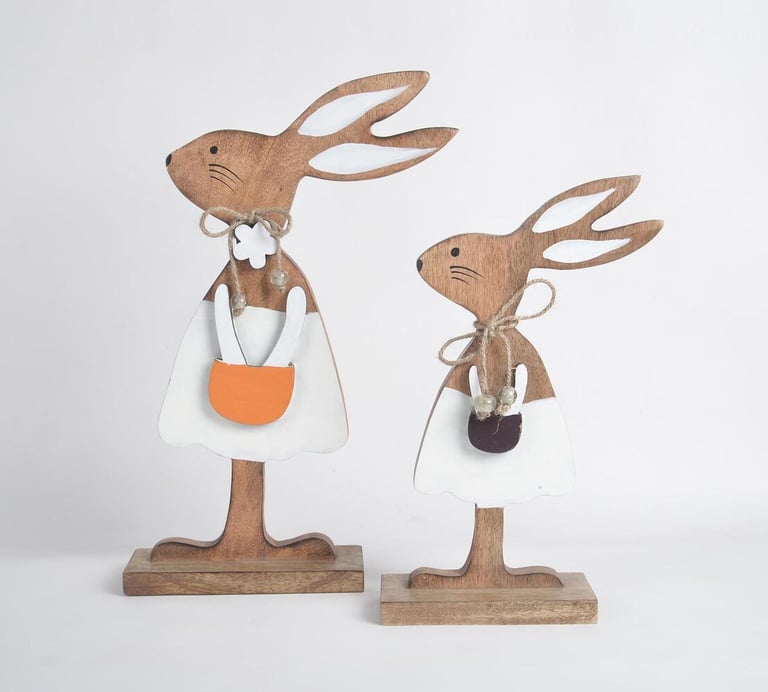 a couple of wooden rabbits with a bag of stuff for easter festival