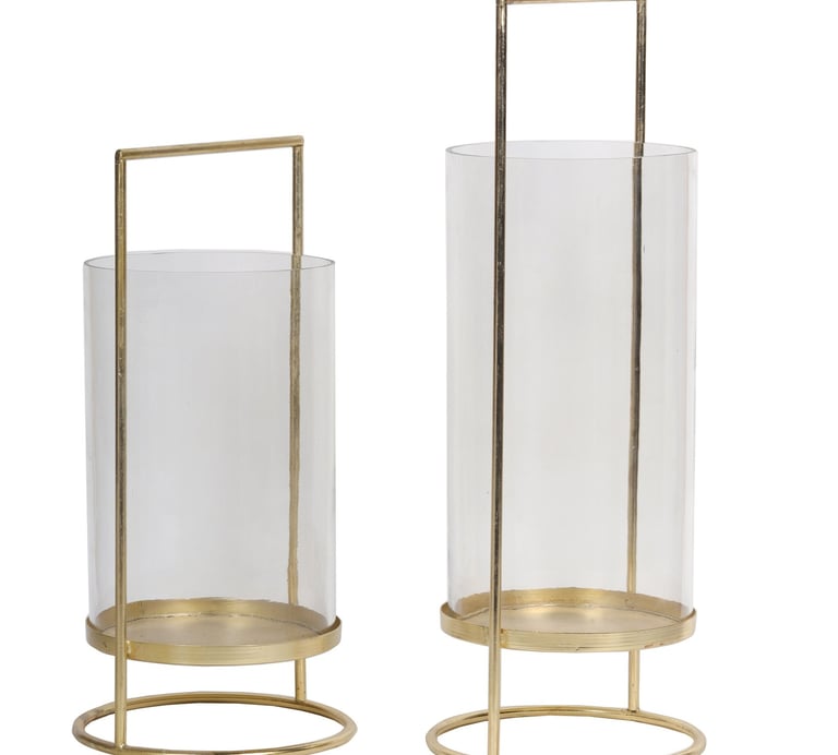 a pair of glass candle holders lantern with a gold metal frame