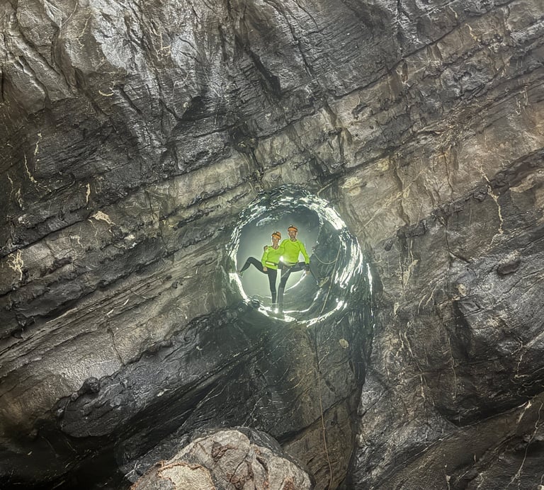 Nick and Tracey Billington climbing through the James Bond hole in Hang Son Doong Cave 