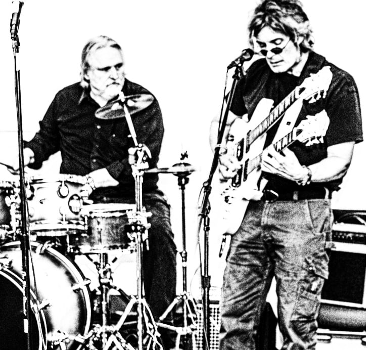 photo of guitarist and drummer playing