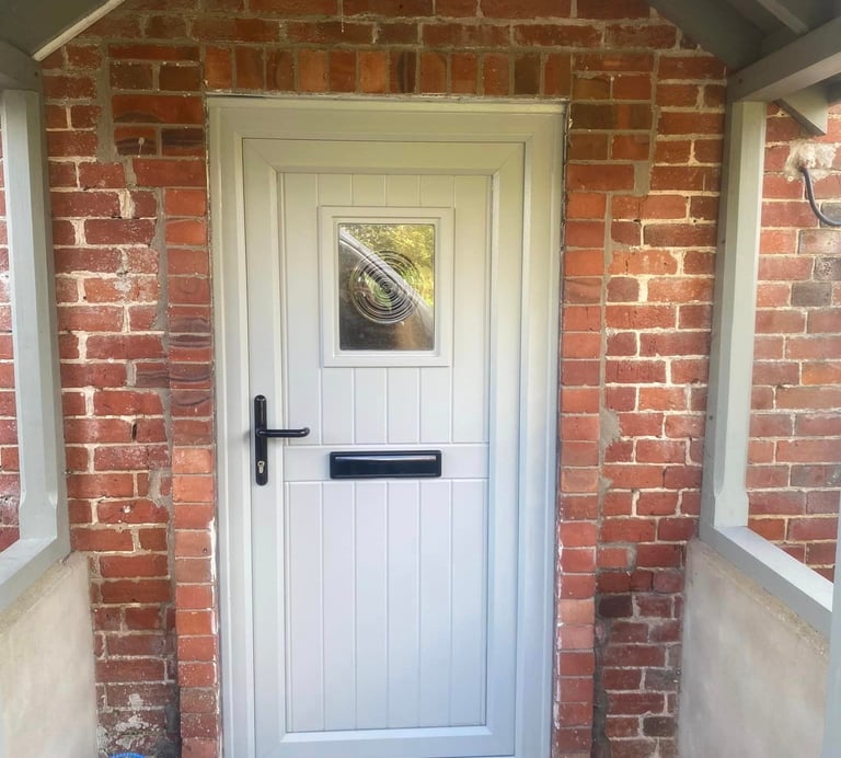 a white door with a black door and a blue bag