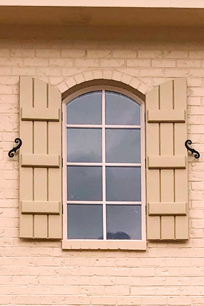 arched top exterior board and batten shutters