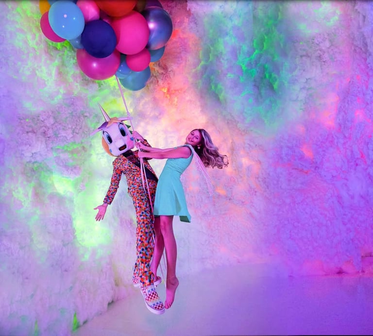 a girl in a dress holding a balloon