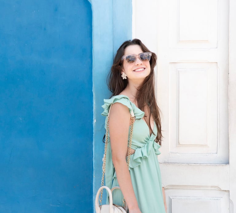 young woman wearing turquoise dress and sunglasses