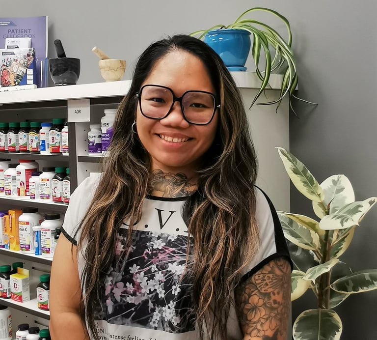 woman with black glasses and dark hair smiling