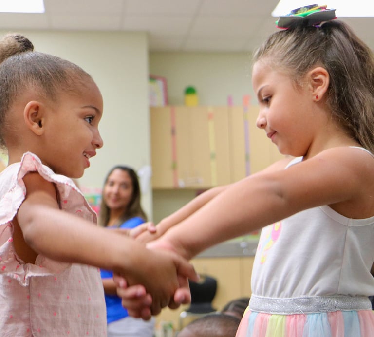 young girls holding hands and moving