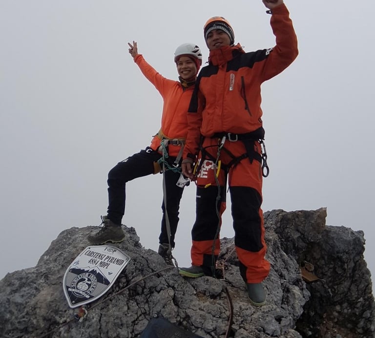 our clinets standing on top of a mountain Carstensz Pyramid - West Papua