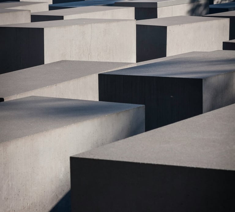  Array of varied concrete blocks with strong shadows.