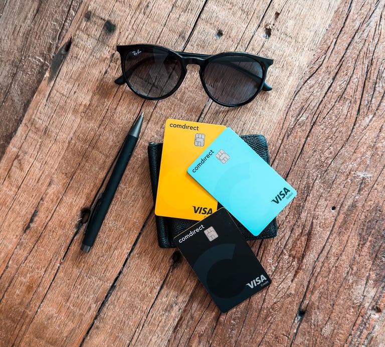 credit cards, sunglasses, wallet, pen on a wooden table
