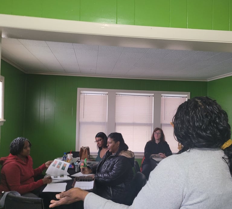 Diverse group of women participating in a collaborative workshop or educational seminar in a green room.