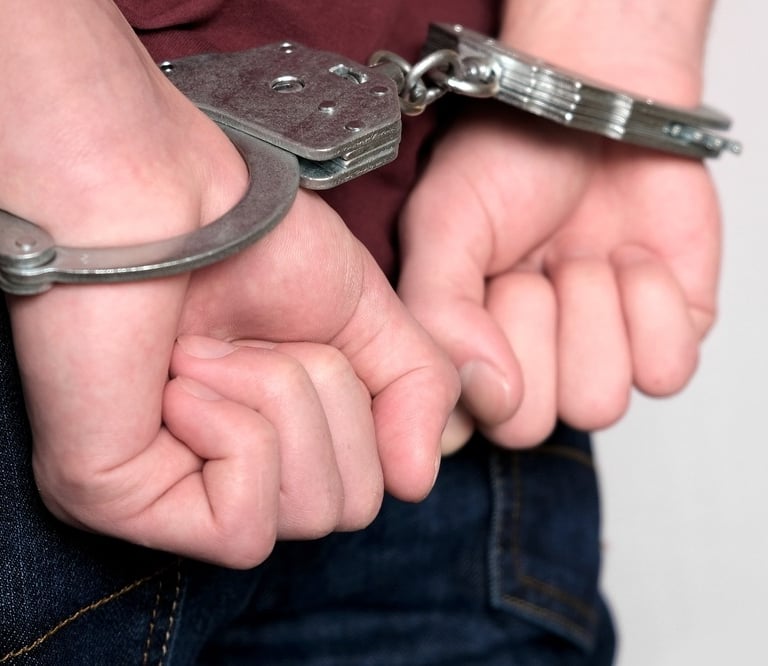 person in handcuffs making fists