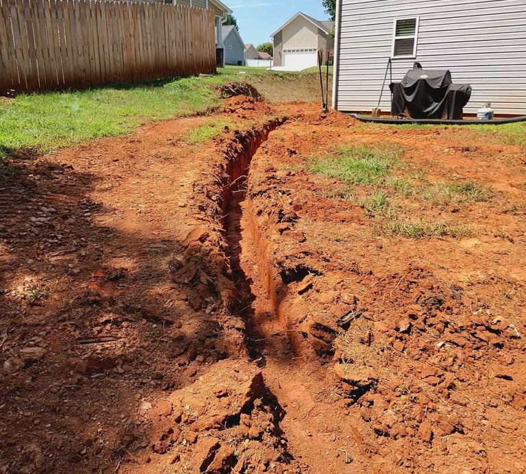 Buried gutter downspout extension connected to underground drainage pipe in Hickory NC to protect ho