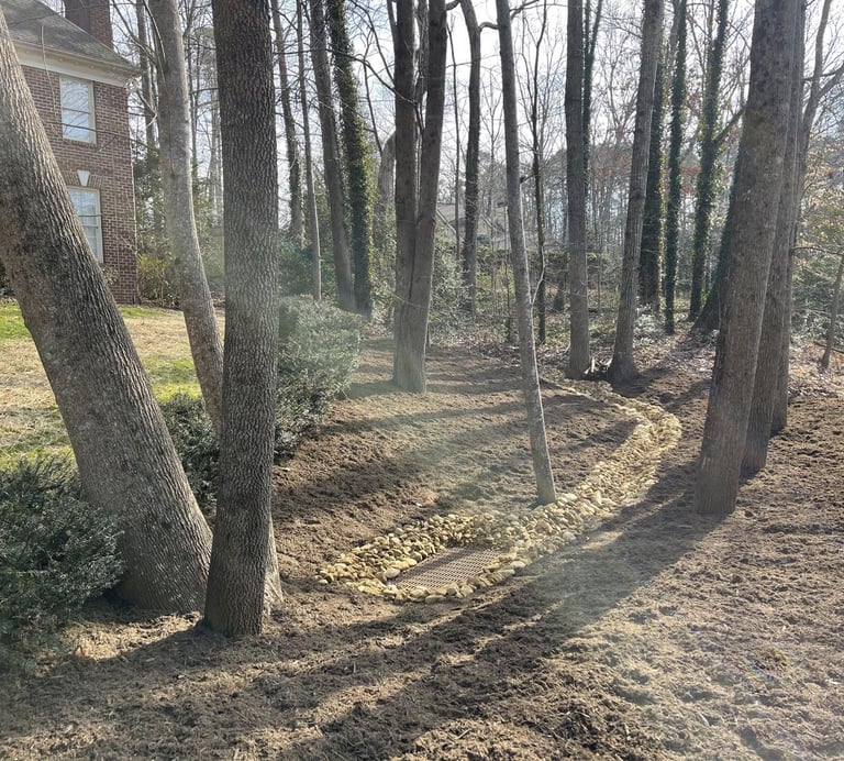 River rock drainage swale with catch basin installation in Catawba County NC to manage stormwater an