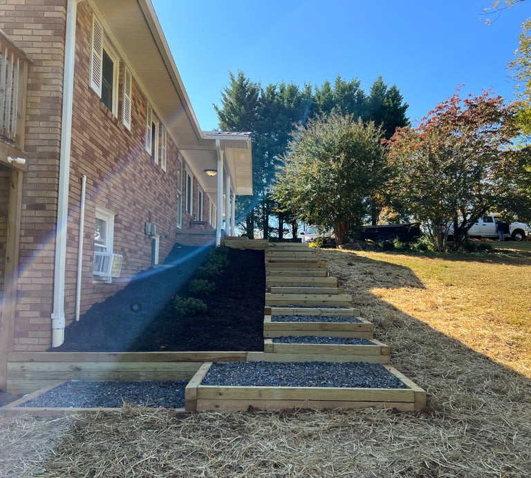 Timber landscape steps installed beside home in Newton NC to manage yard slope