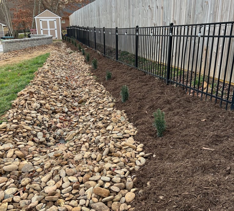 Dry creek bed drainage system installation in Newton NC to control runoff and reduce erosion along p