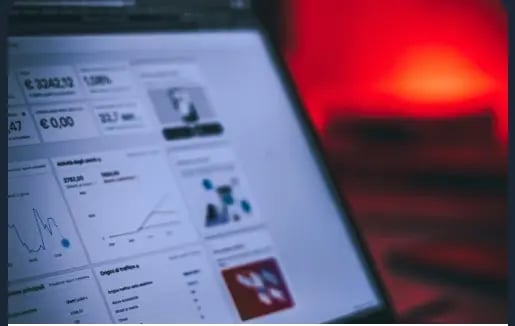 A laptop screen displaying keyword research and SEO analytics charts.