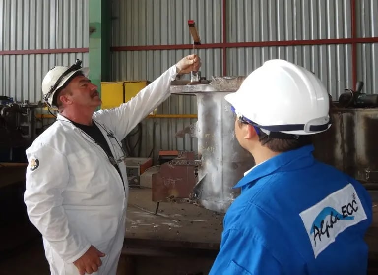 Engineers performing quality control inspection on industrial equipment.