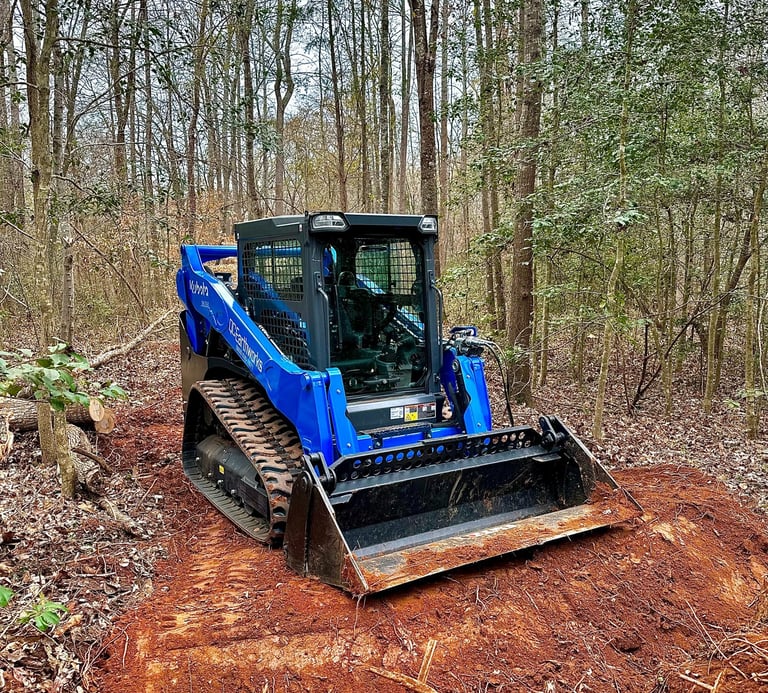 Skid Steer Clearing a path through the woods