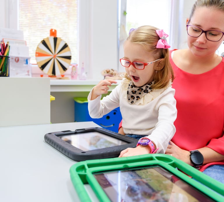 Parent engaging with toddle during a supportive, family-centered therapy moment.