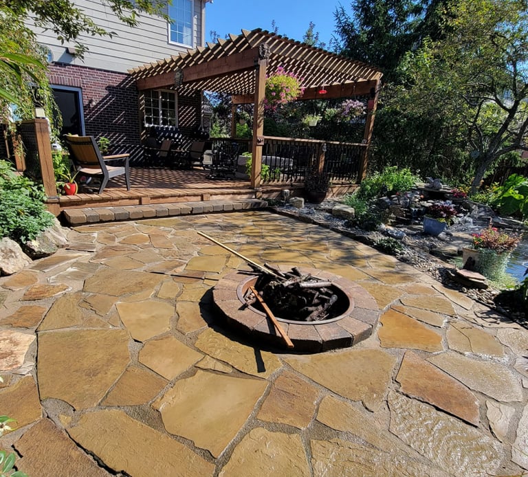 Custom flagstone patio and firepit installed for a customer by Kingdom Landscape