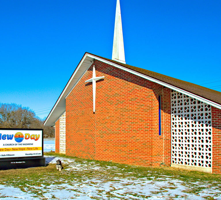 Our church with our new sign, photobombed by the Pastor's dog, Scamp.