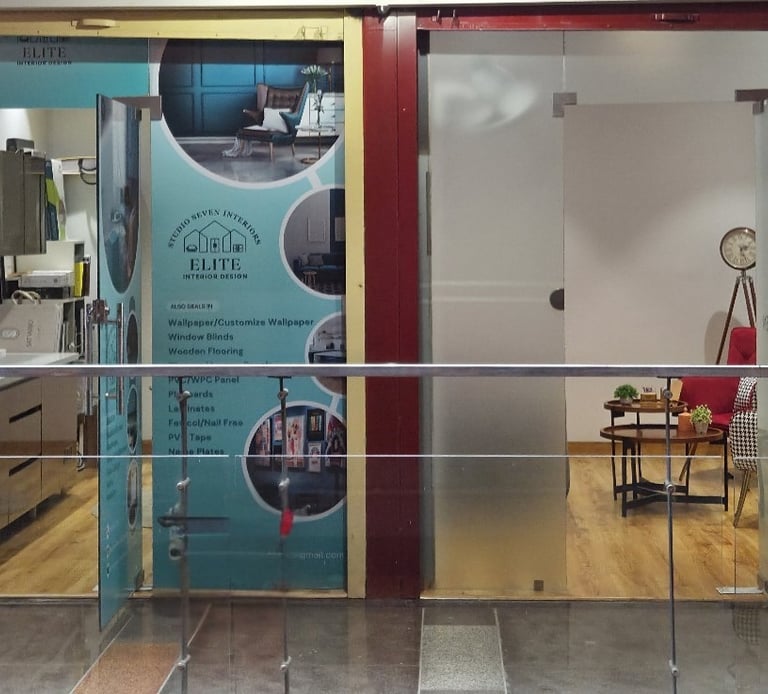 Elite Interior Design studio storefront with glass doors and decorative wallpaper samples.