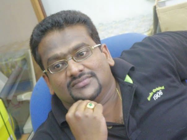 a man in a black shirt and glasses