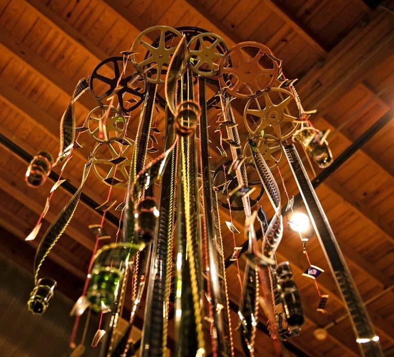 35mm film rains down like water from a 9.5 tall sculpture that hangs from the ceiling.  