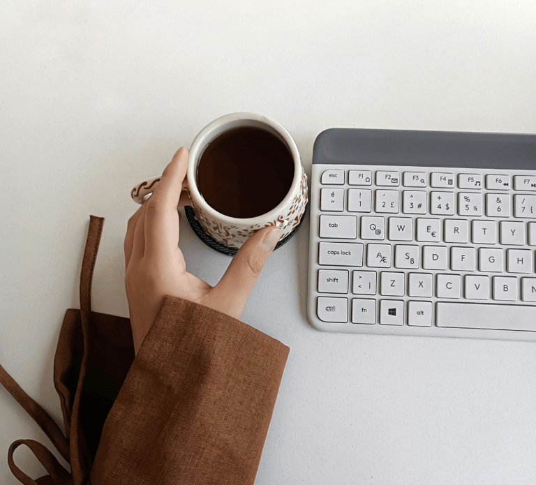 Mesa de trabalho com teclado e xícara de café, energia limpa e o foco mental  pelo café premium