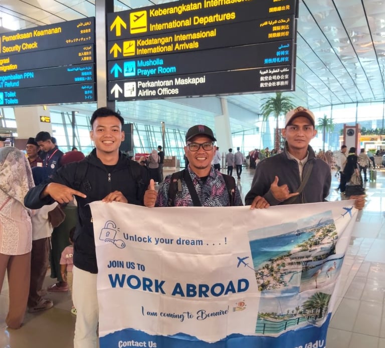 crew holding AKA banner at an international airport terminal.