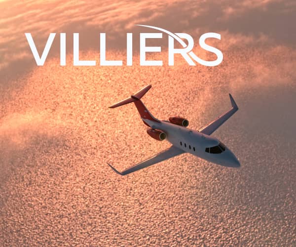 Villiers Jet luxury private jet flying over the ocean, showcasing comfort and exclusive booking opti