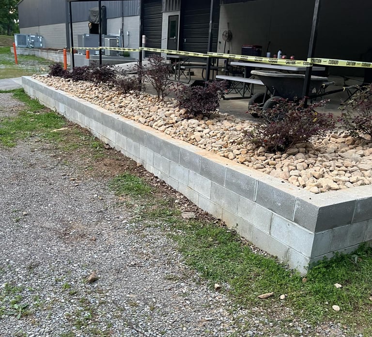 retaining wall holding rock and plants