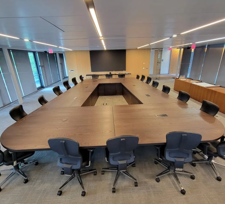 22ft x 14ft custom white ash conference table with fabricated wood legs — full installed view