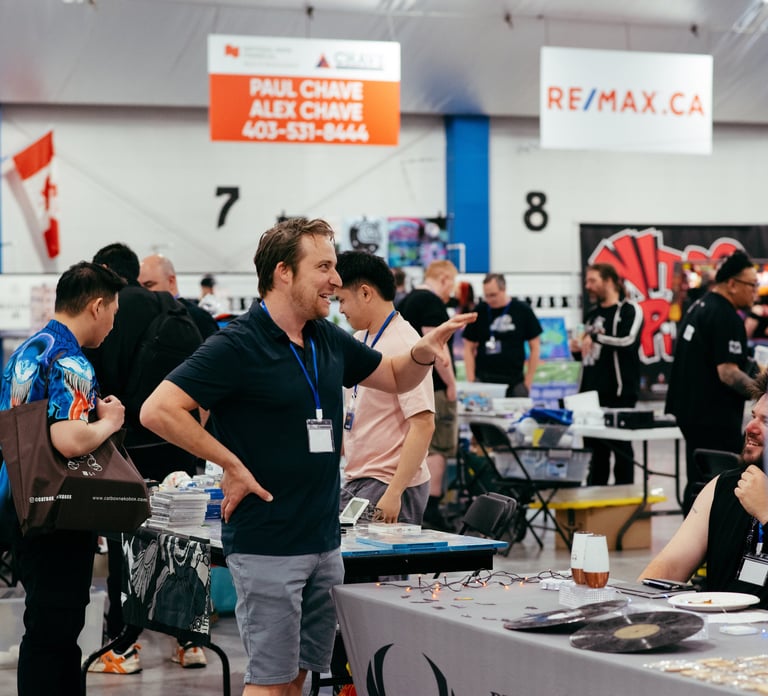 A volunteer smiles and gestures as he excitedly talks with a vendor at the event