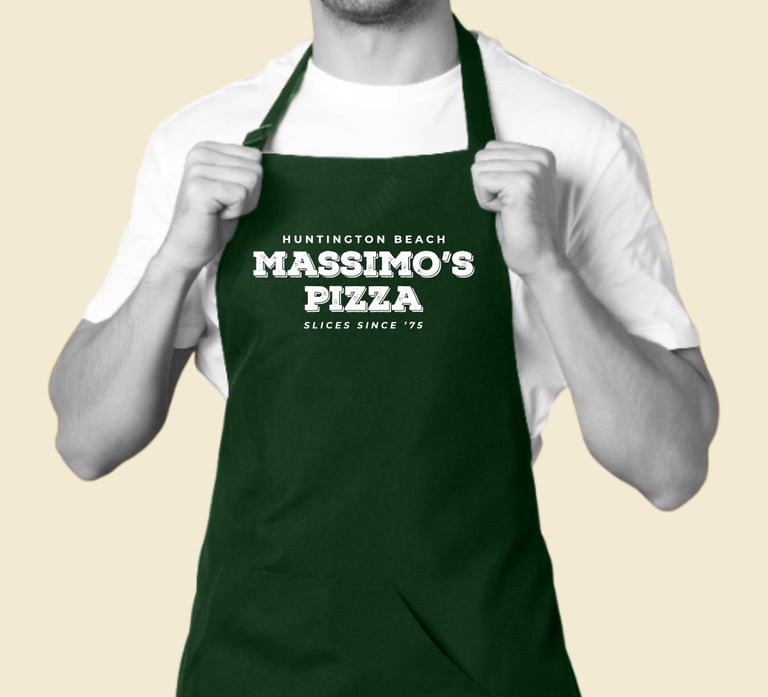 Massimo’s Pizza rebrand logo printed on green staff apron.