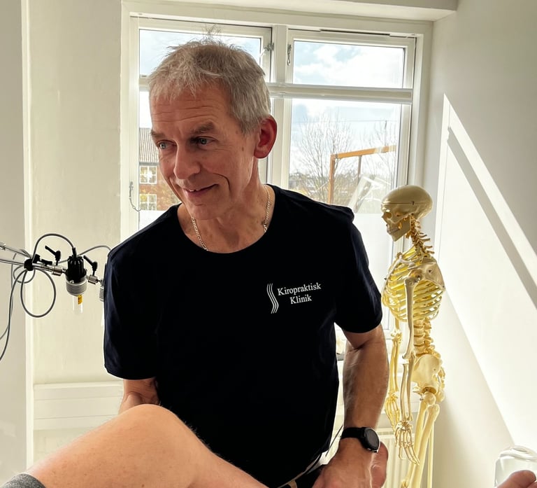 a man in a black shirt is sitting on a table