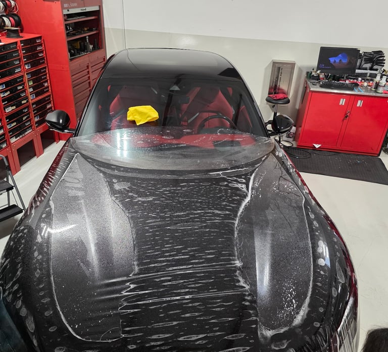 Overhead shot of an active Paint Protection Film (PPF) installation on a Ferrari Purosangue hood by 