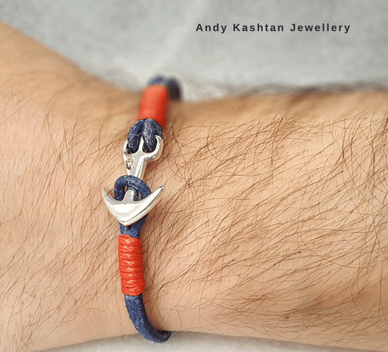 Handmade men's silver anchor bracelet with navy blue and red leather cord on a wrist.