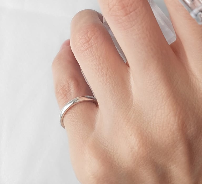 a person's hand with a ring on it