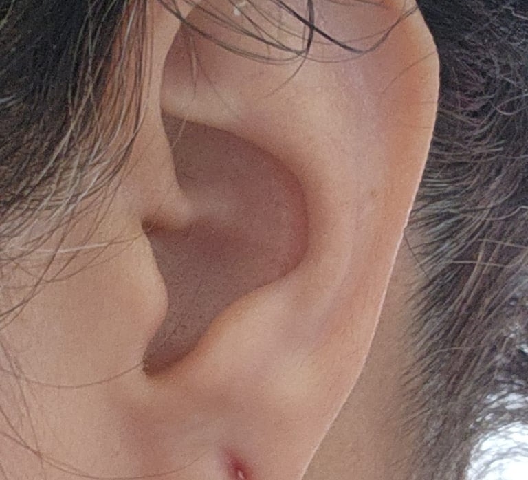 a woman with a piercing on her ear