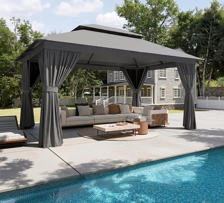 Modern grey outdoor gazebo with curtains over a poolside patio lounge area and sectional sofa.