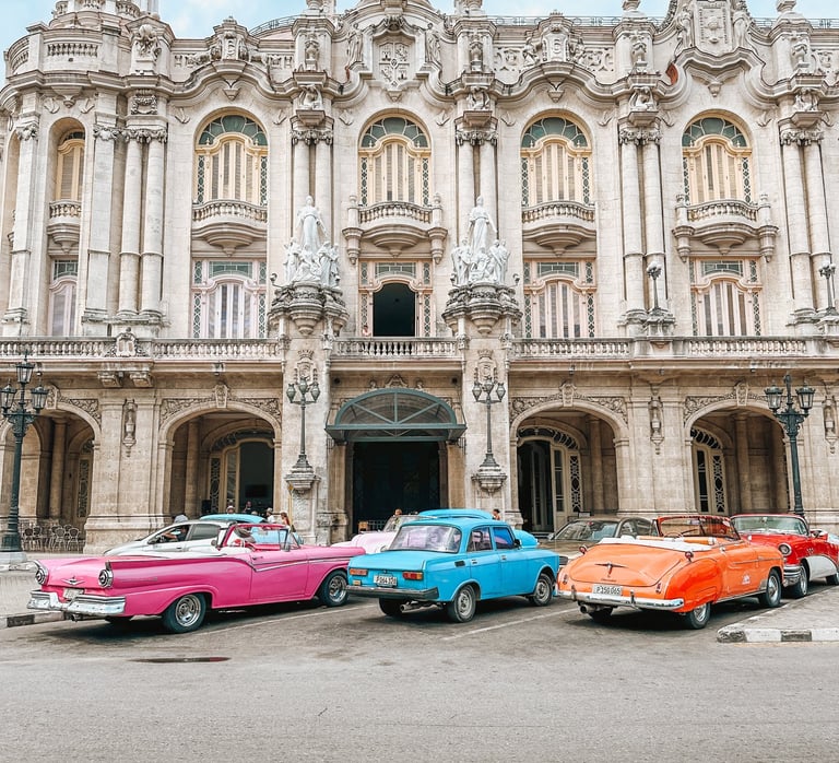 Classic cars parked in front of a building in Havana, Cuba