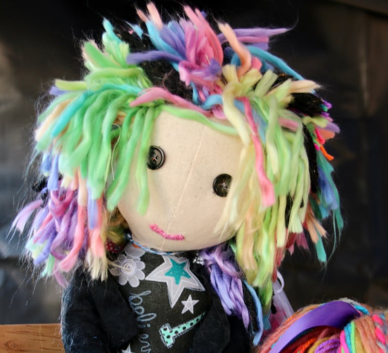 photo of a rag doll styled to look like a female punk